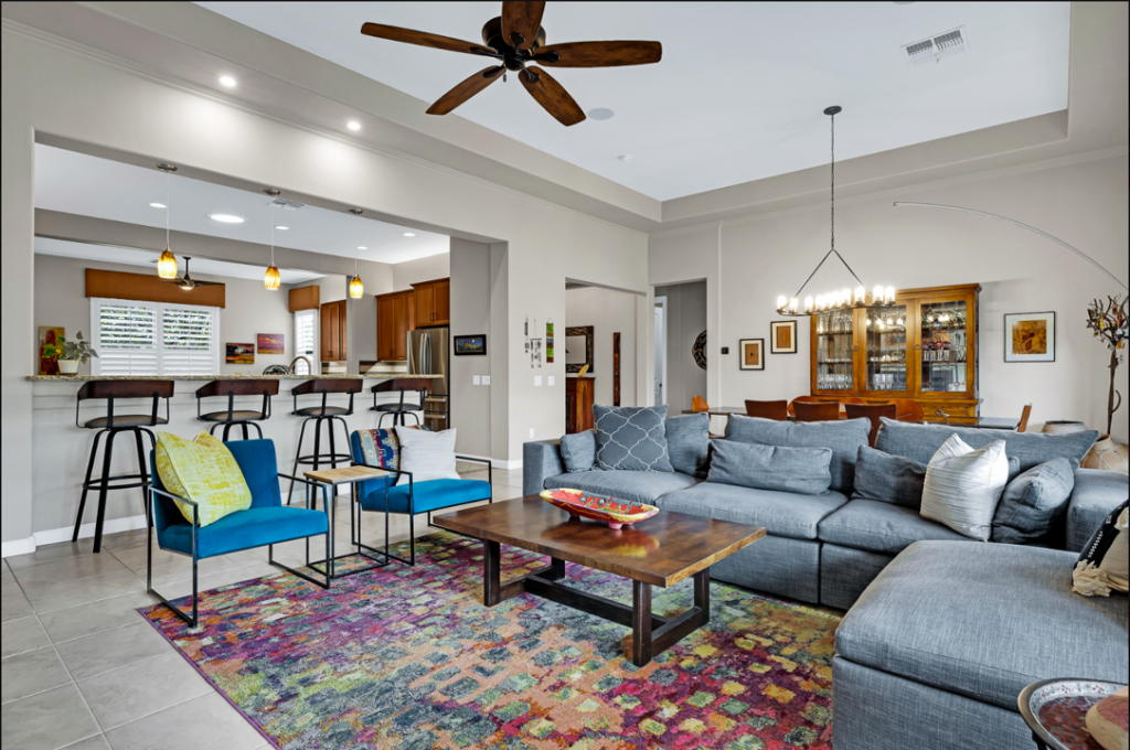 gray wall color in three tones with colorful furniture and art in contemporary great room with modern chandelier