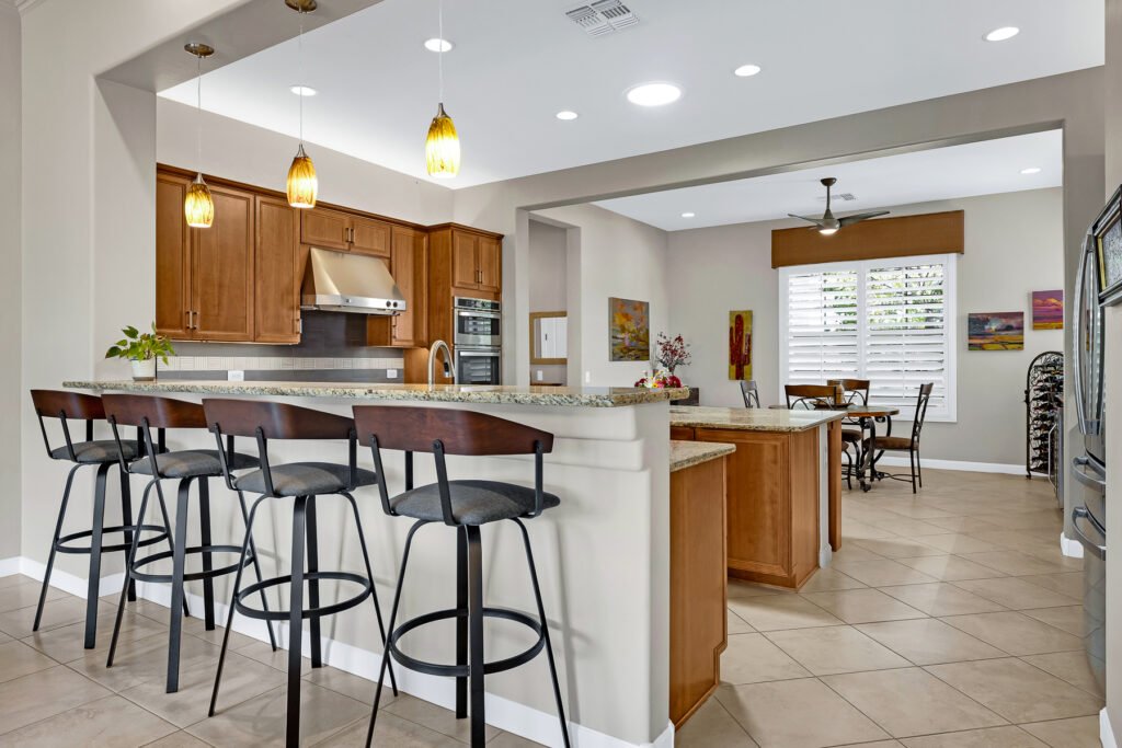 gray paint kitchen contemporary stools in dark wood and gray fabric, medium tone wood cabinets orange glass pendant lights